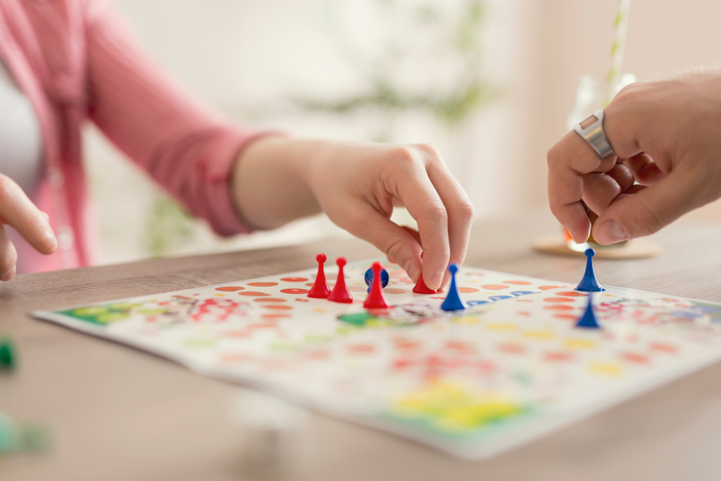 two person playing a board game in the house