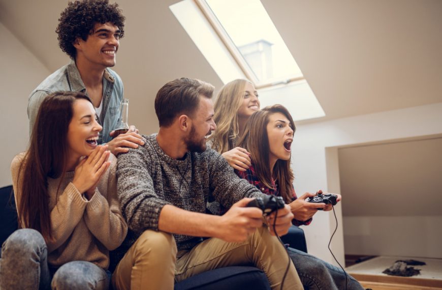 group of friends playing video games at home