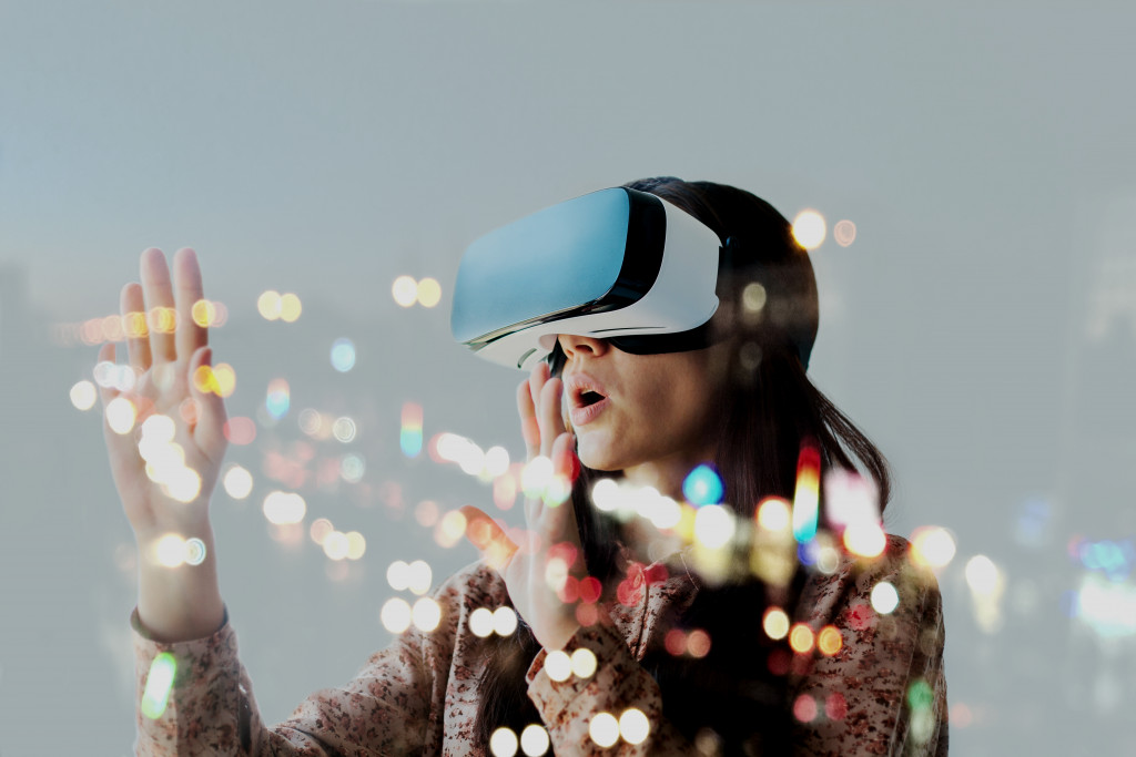 woman using AR VR glasses to play a game